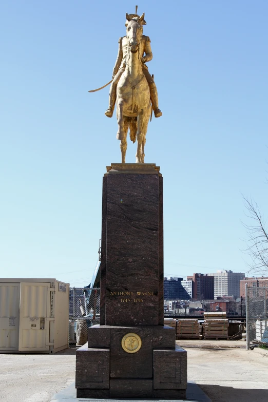 a statue of a woman riding a bull in a parking lot