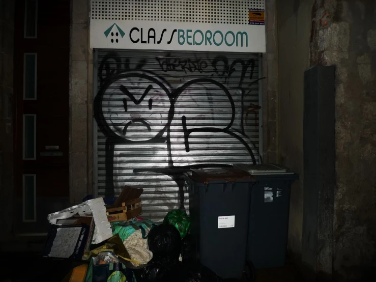 a building with a metal door has graffiti on it