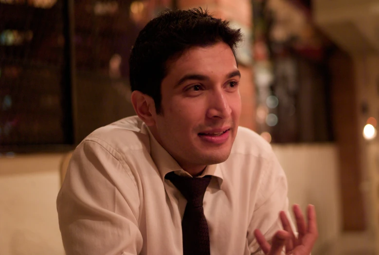 a young man wearing a white shirt and tie