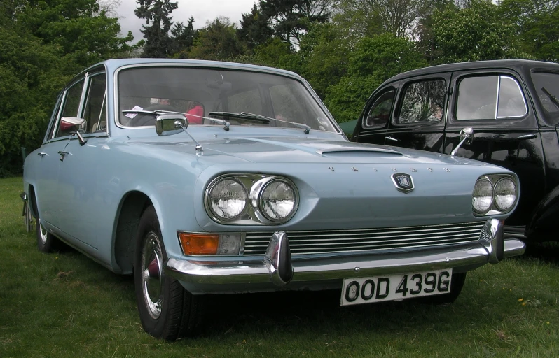 a old car is parked in the grass