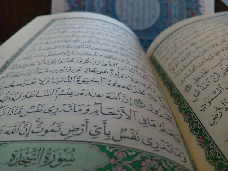 close up of an islamic prayer on top of a book