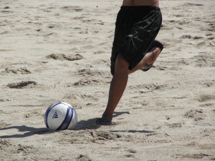 a man that is standing next to a ball