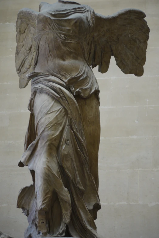 a statue of an angel holding a man's body