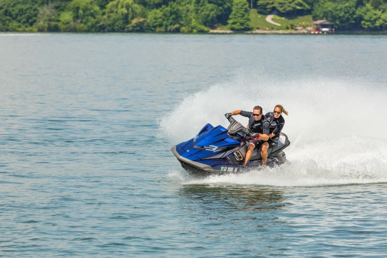 a couple riding a jet ski on top of water