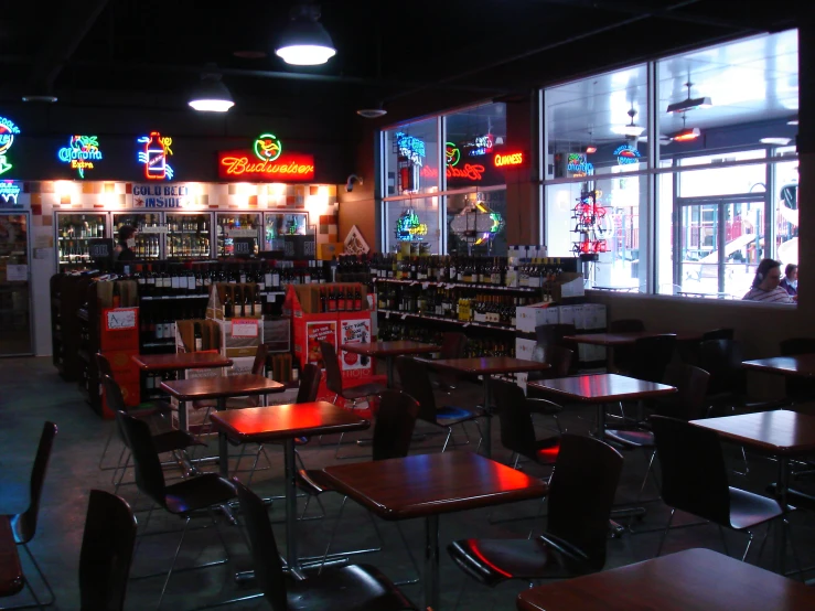 a dimly lit restaurant has a long display and stained glass windows