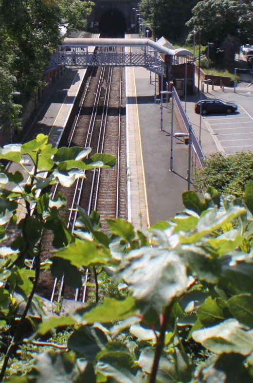 a subway train traveling down train tracks next to a platform