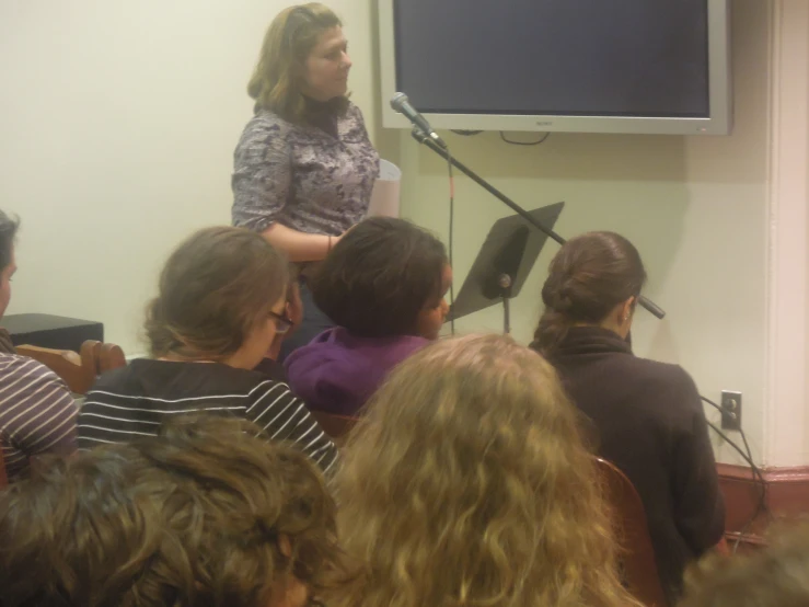 a group of people in a room with speakers