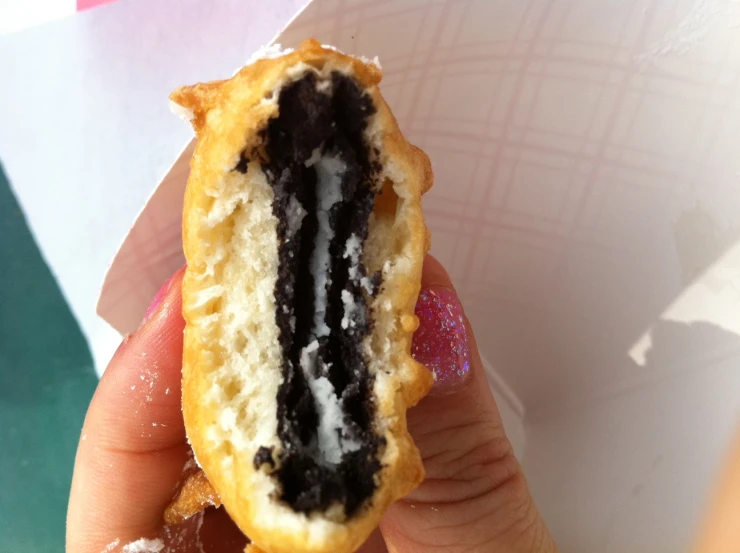 a small pastry has chocolate and white cream in it