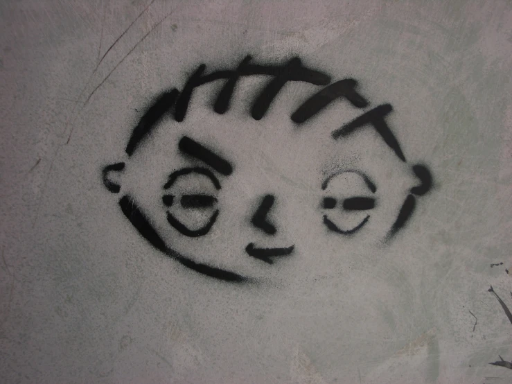 graffiti on the wall of a boy's face