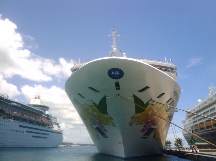 two cruise ships side by side and a dock