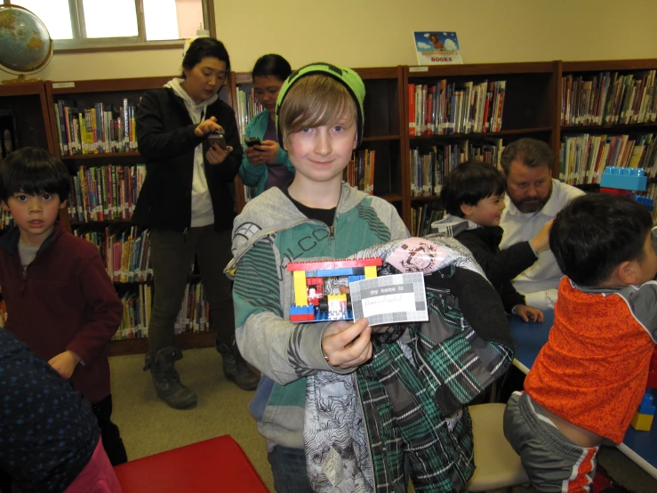 a boy is holding a toy in his arms