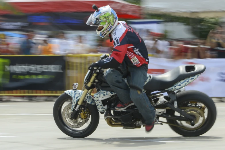 the motorcycle rider is wearing a red and blue jacket