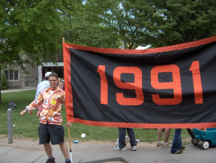 an older man standing next to a sign that says 1911