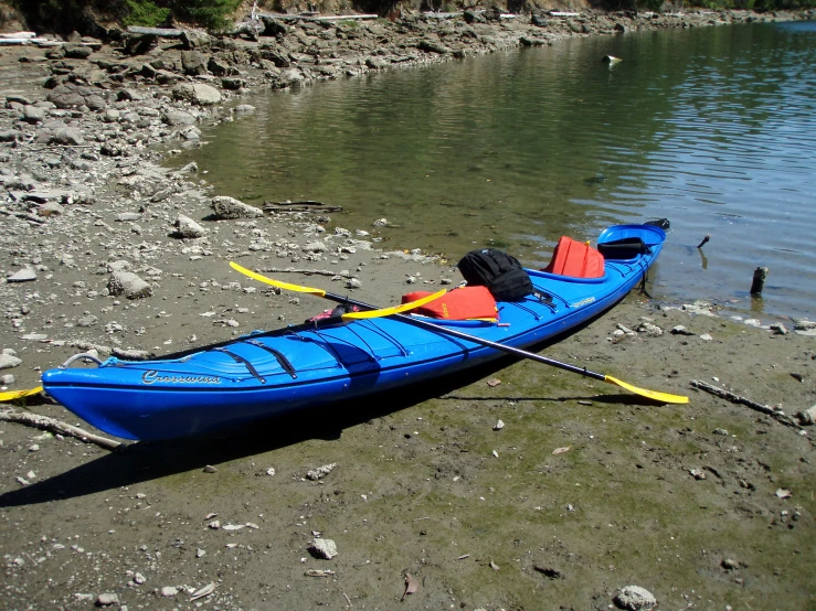 a blue canoe is on the water and ready to go