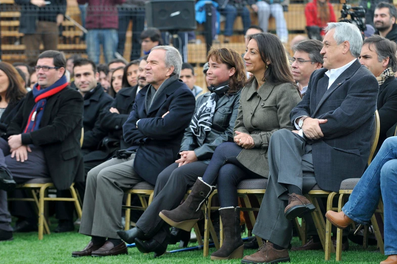 an audience with people in the stands in chairs at an event