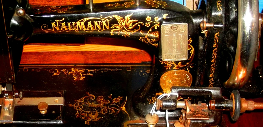 an antique sewing machine with gold and ornate carvings