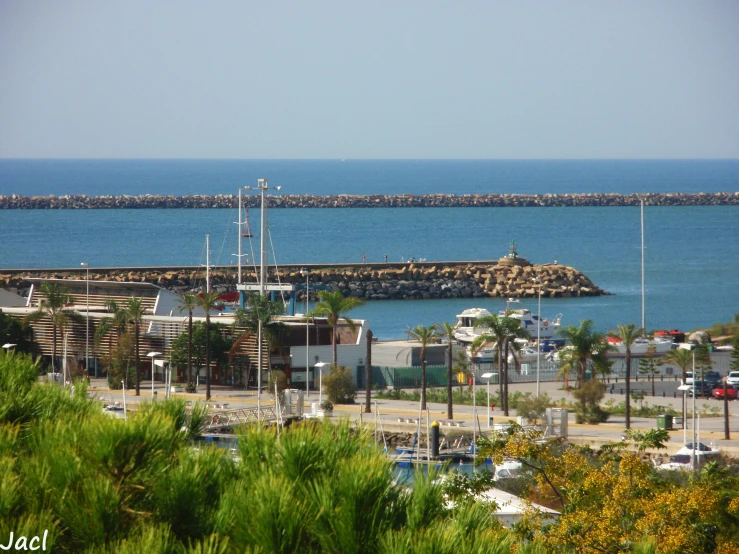 a harbor area with a pier on the other side and cars