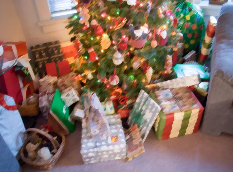 a christmas tree with presents all around it