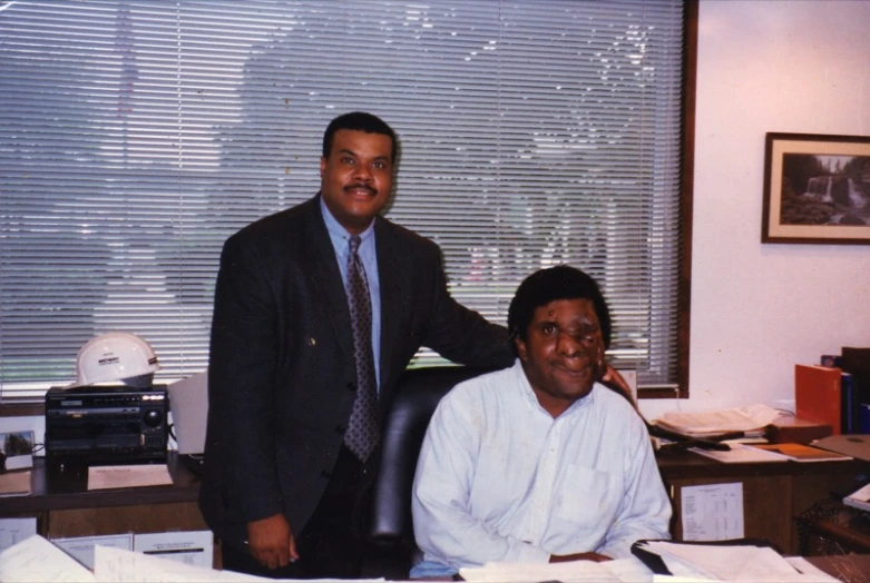 the two men pose for a po in their office