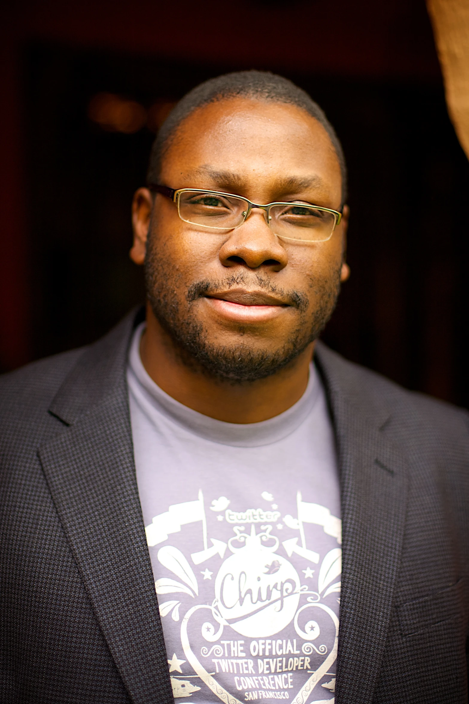 a man wearing glasses and a t shirt