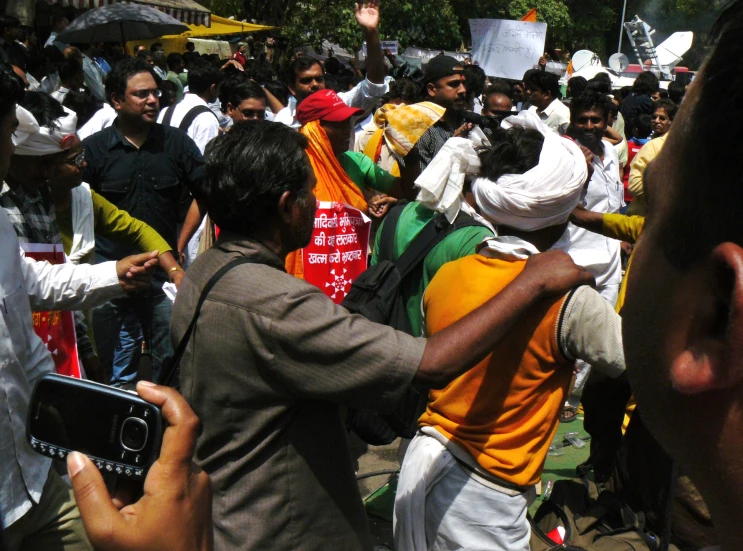 the men are all holding signs with a lot of people