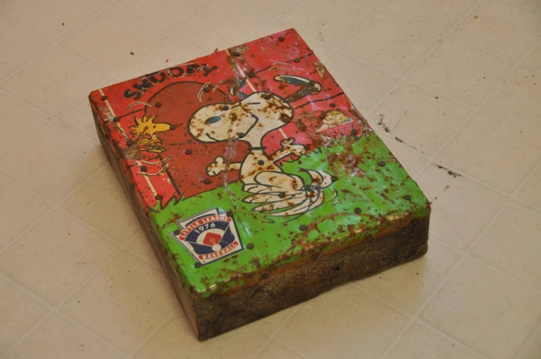 a square, rusty square with a dog on it