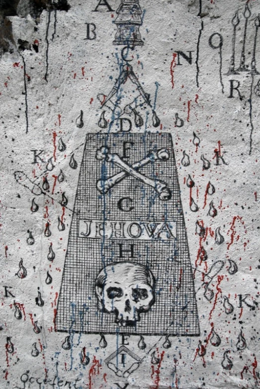 an artistic painting on cement with a skull and crossbones