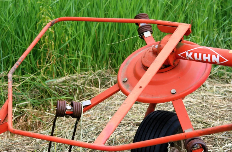 there is a red wheel attached to the lawn cart