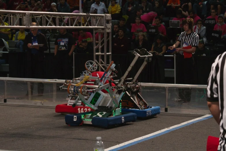 a miniature mechanical race being ridden by referee at an event