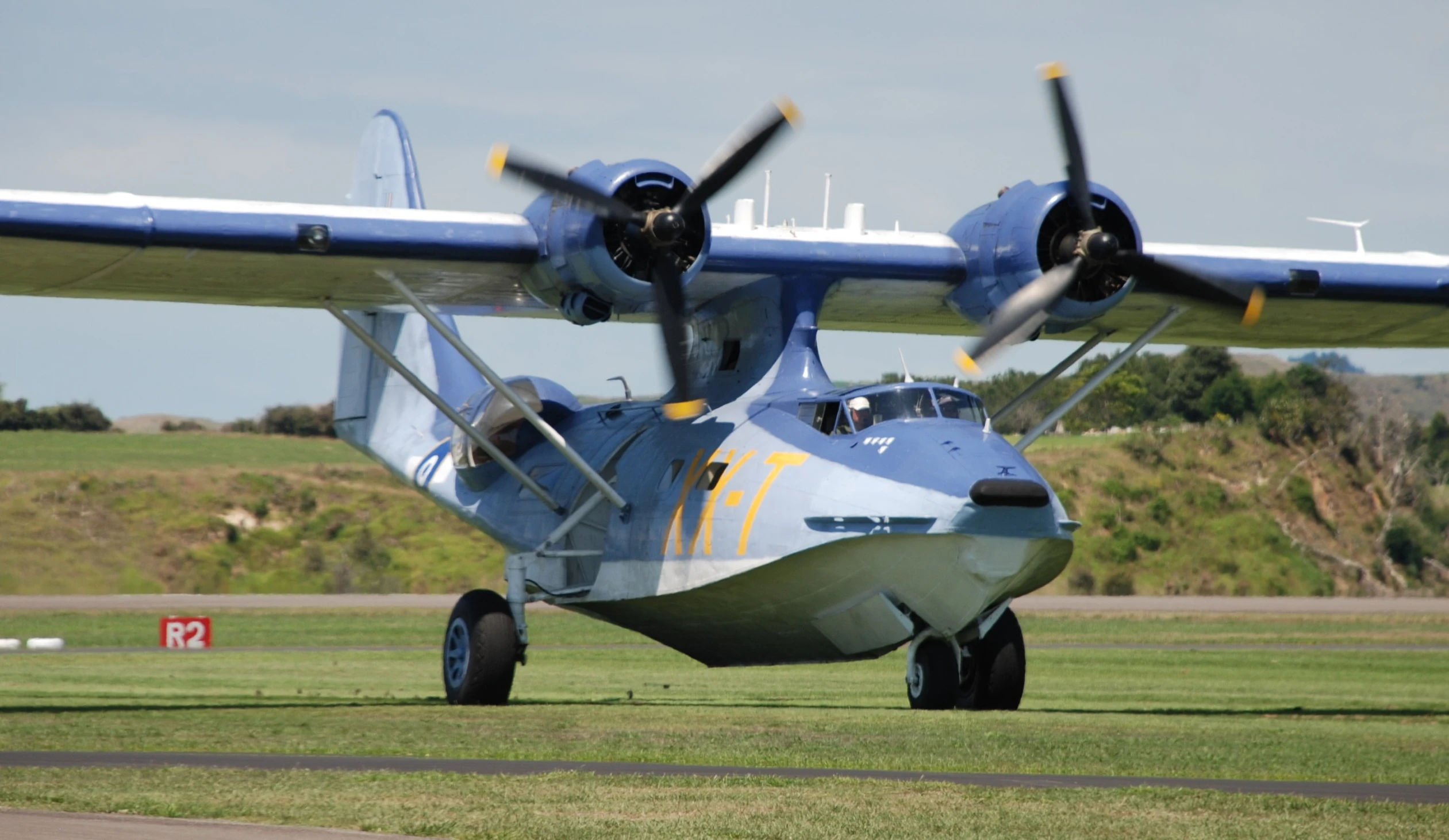 a big old plane sits in the grass