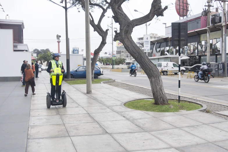 the man is riding a wheeled device through the town