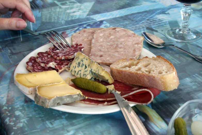 a close up of food on a plate near wine glasses