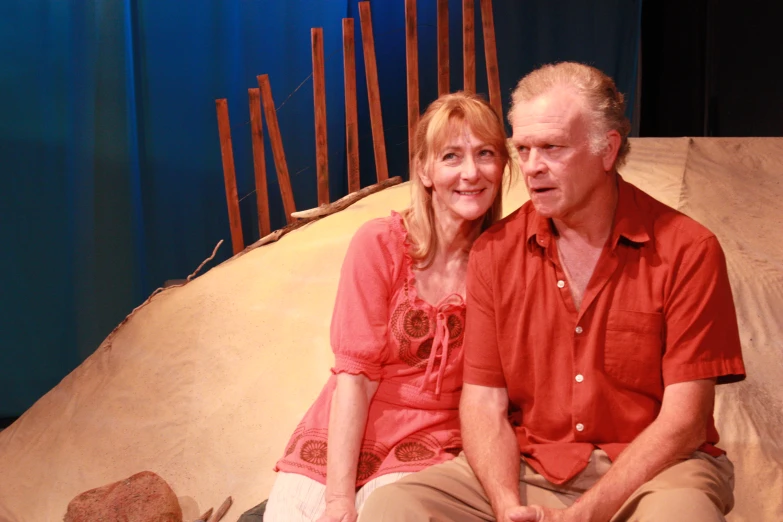 a couple poses for a portrait on stage