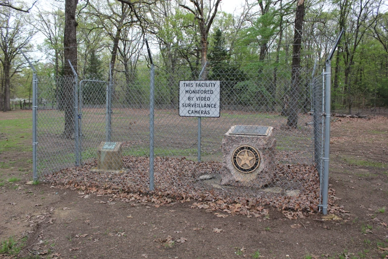 a park is fenced off with rocks and leaves