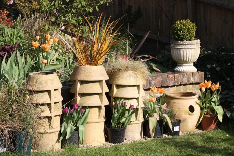 a garden filled with lots of potted flowers