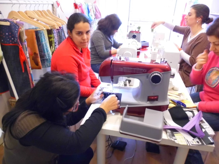 a group of women working on sewing machines