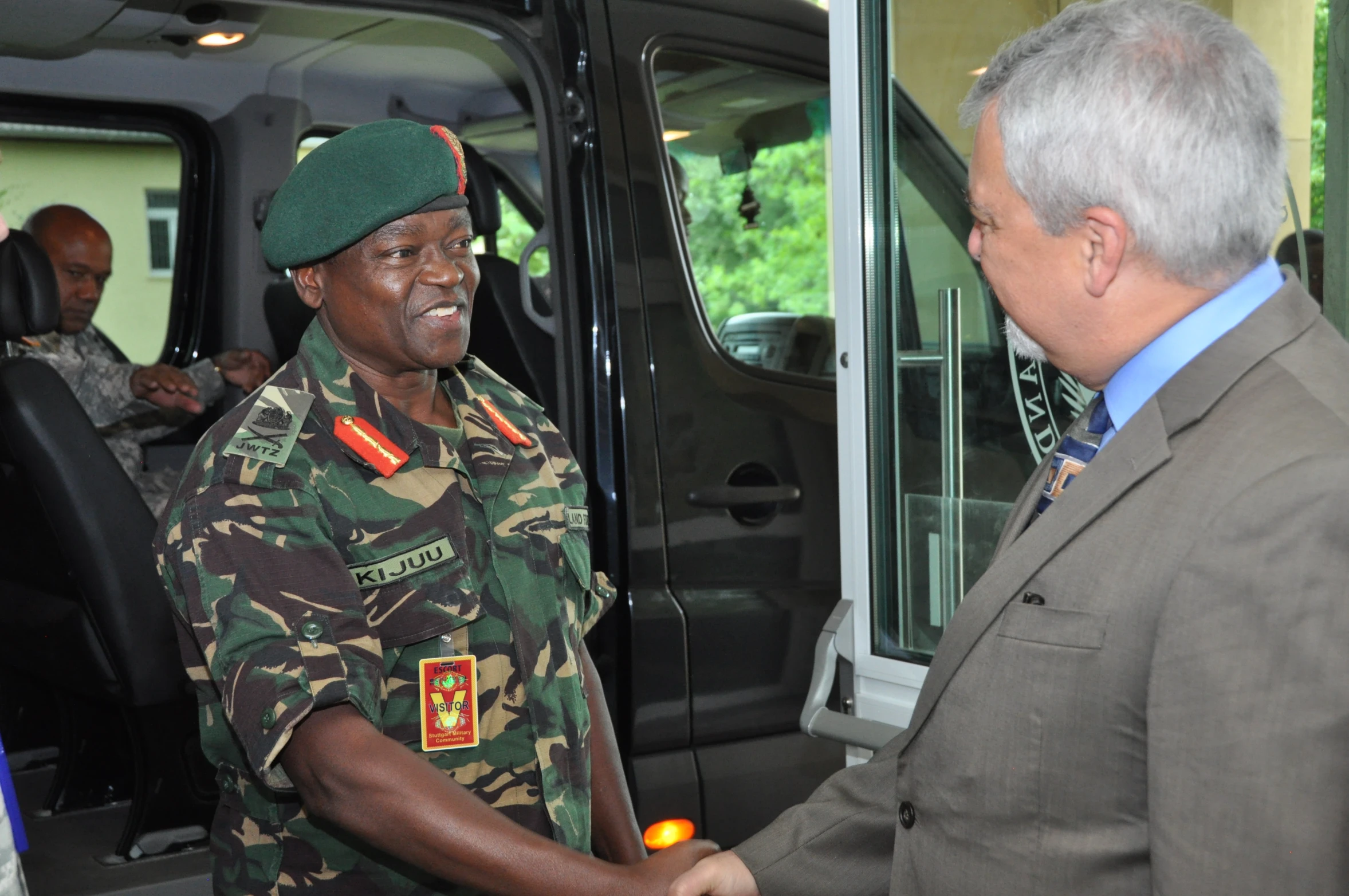 a black man shaking another black man's hand