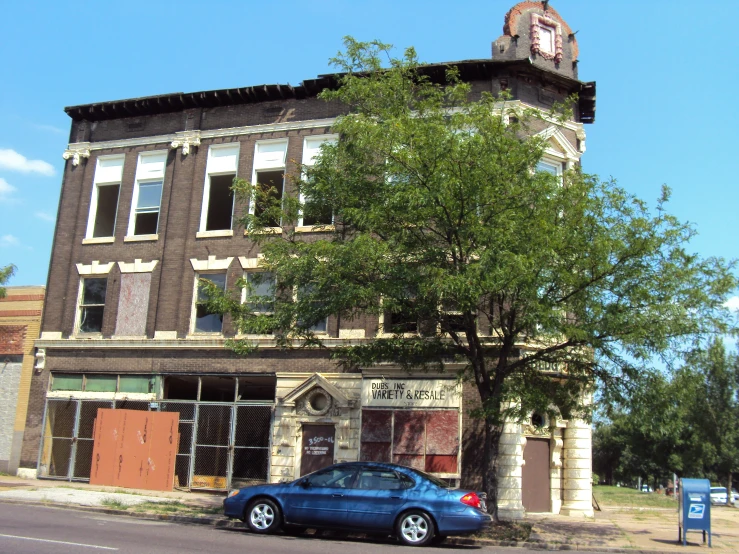 a small car parked in front of an old building