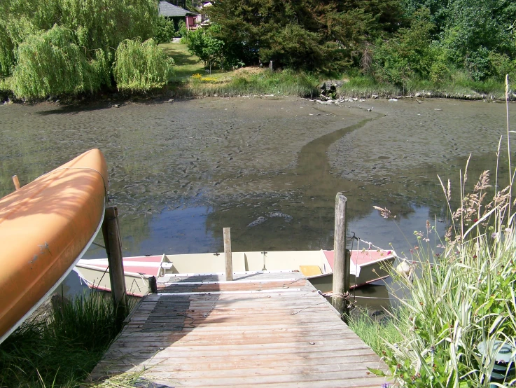 a canoe tied to a dock with a ramp for boats