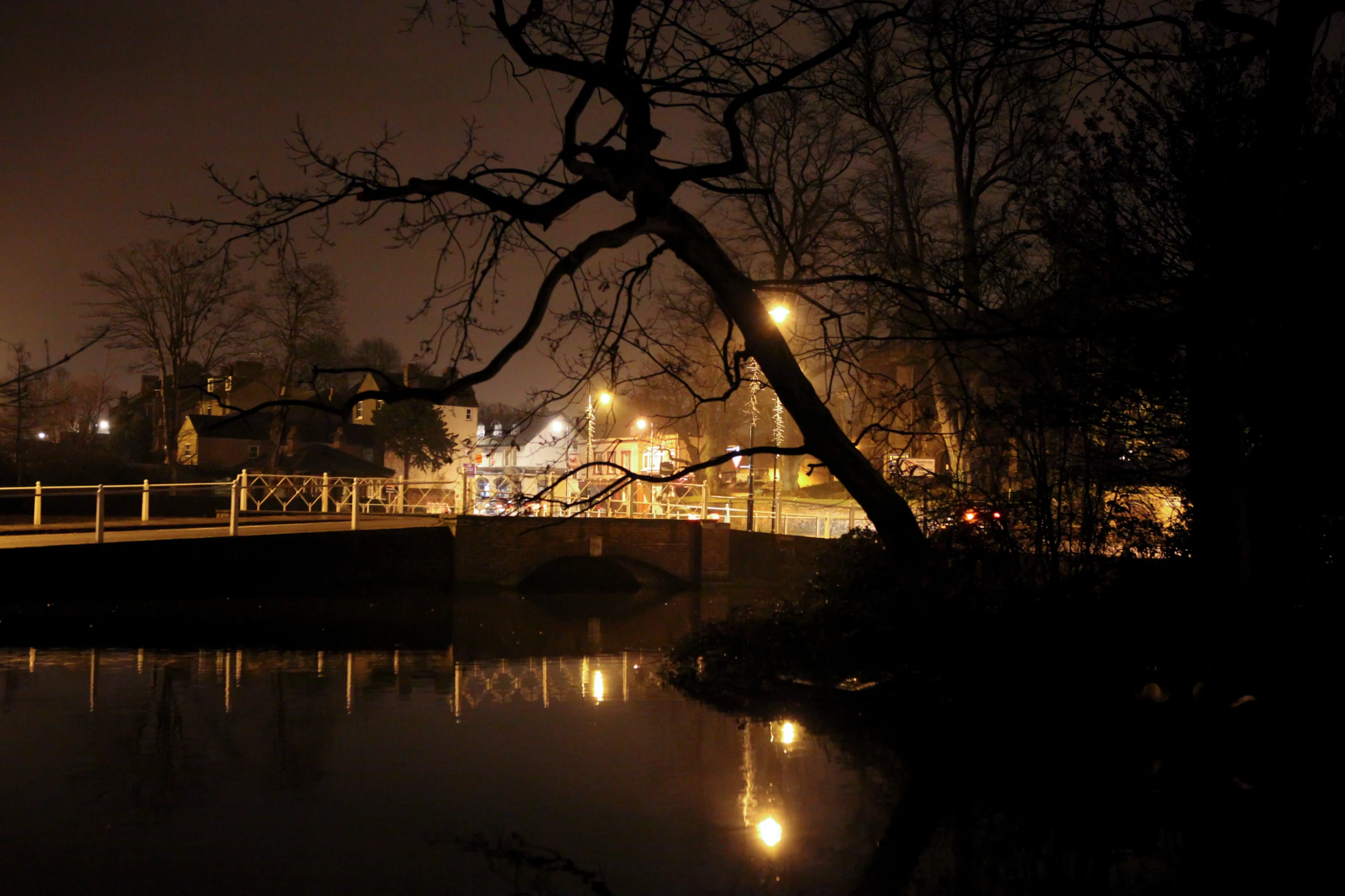 an illuminated city scene with the bridge at night