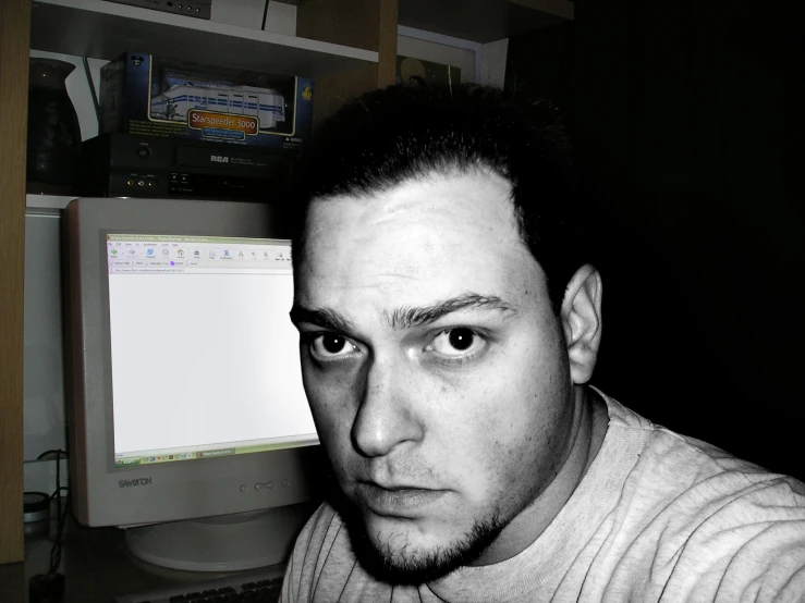 a black and white po of a man in front of a computer