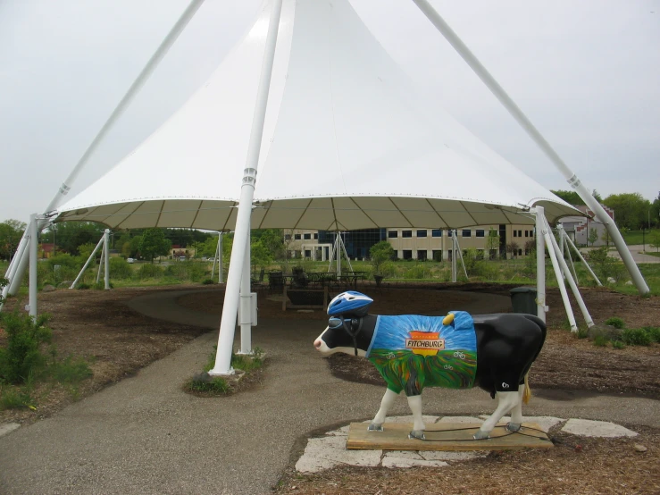 some white poles and a big cow statue