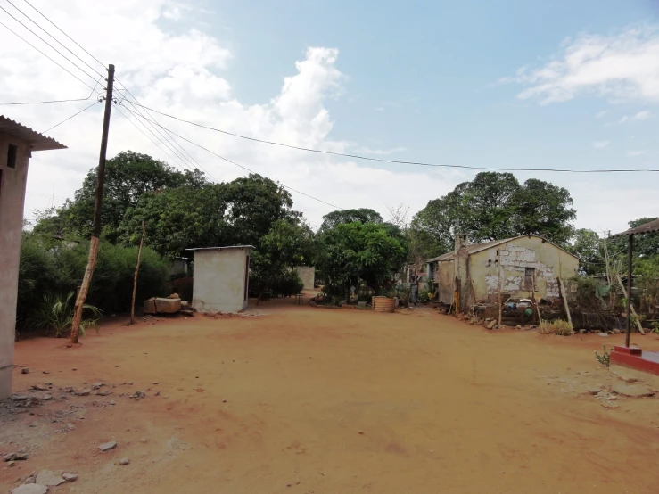 an empty road surrounded by several buildings