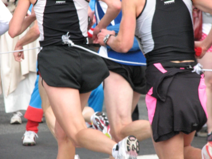 some people are running in the street and one is being filmed by another person