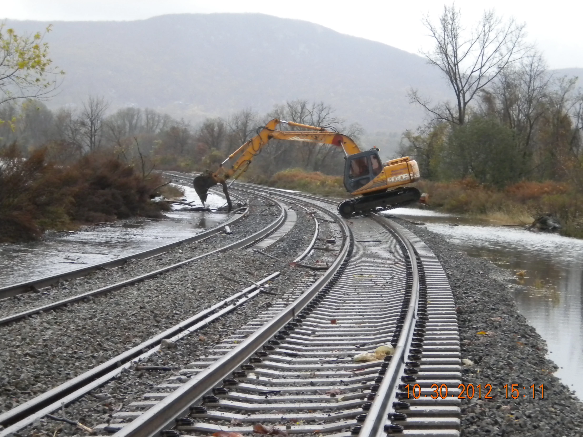 a train track with machinery is laying on it