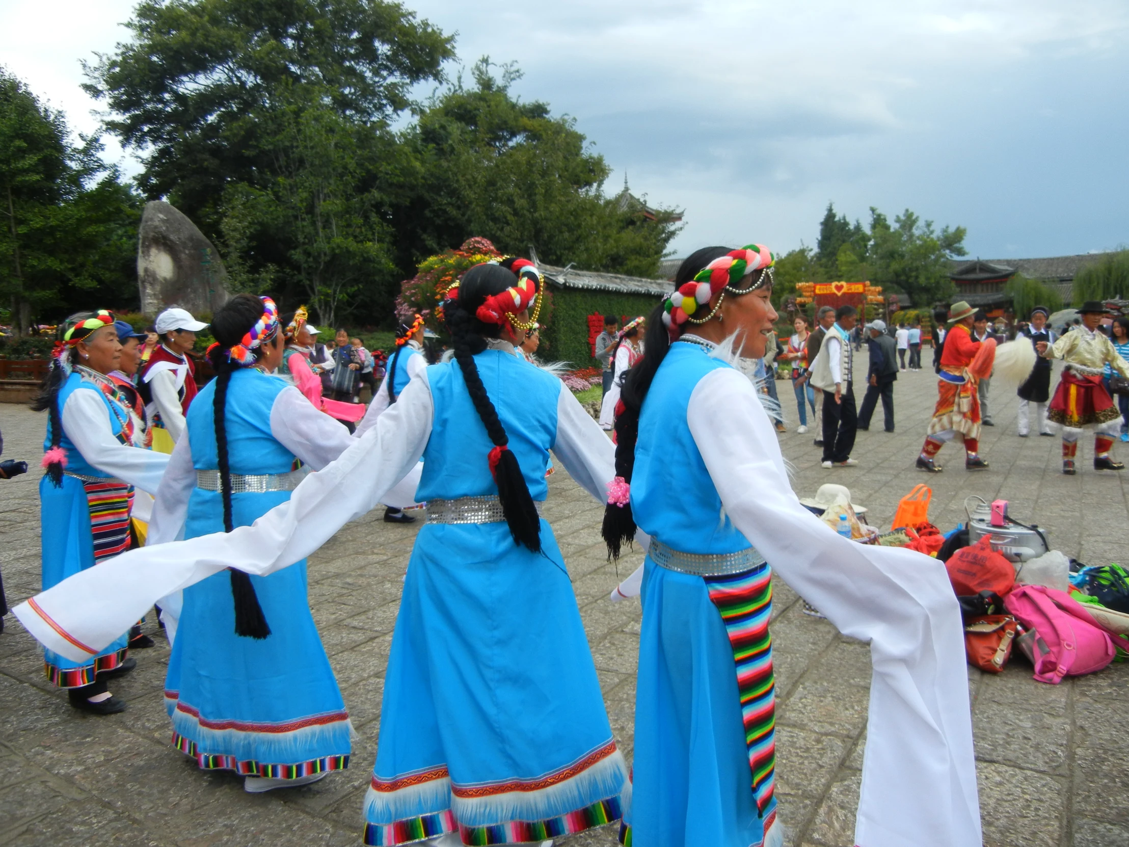 dancers in traditional costumes perform in front of a group of people