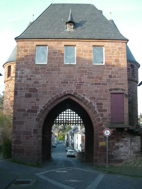 an old brick building with some doors open