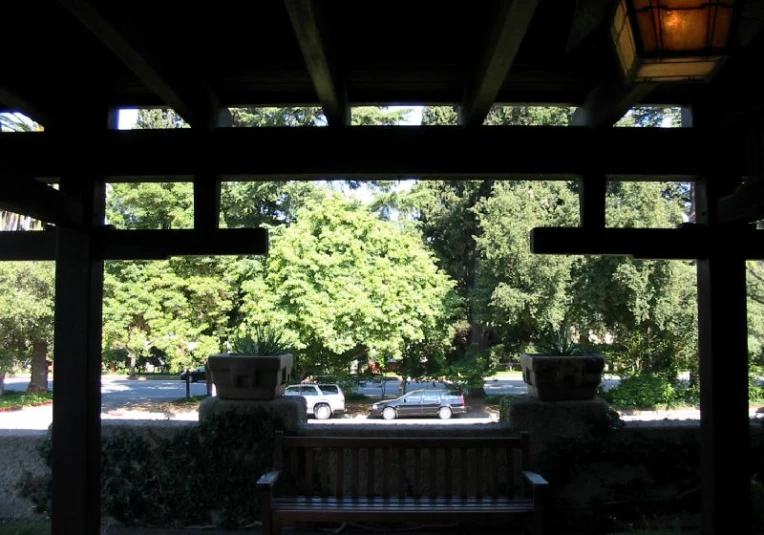 an open covered parking garage with a bench underneath