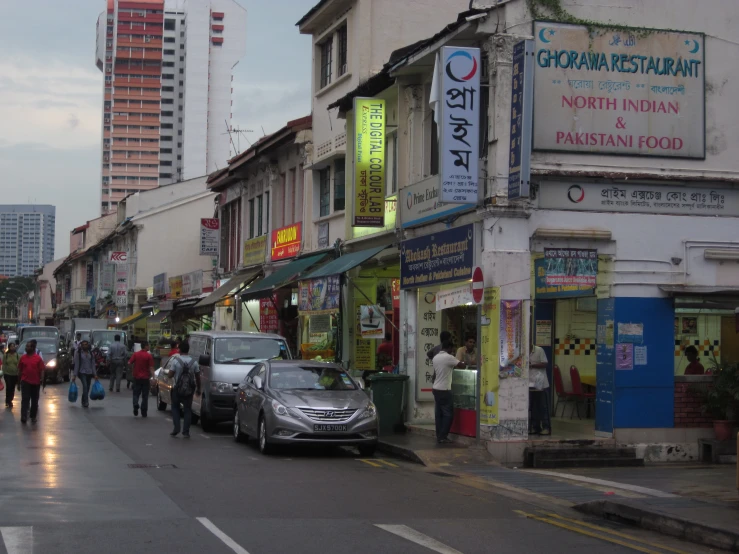 a street filled with people, cars and buildings