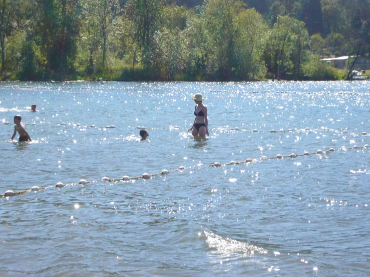 a group of people stand in a body of water